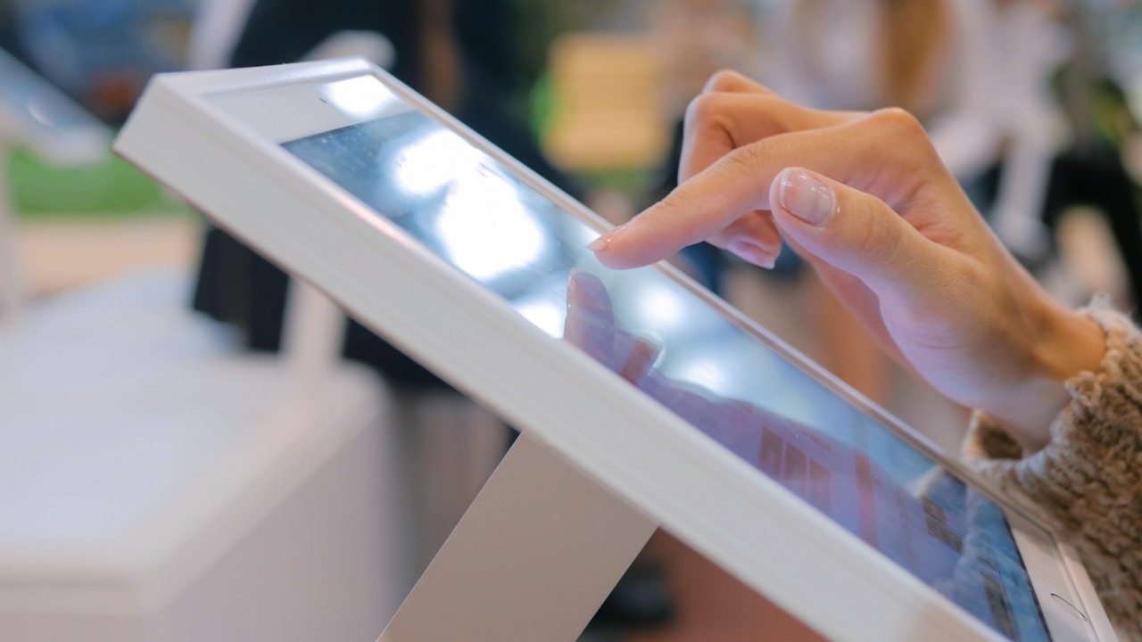 Woman,Using,Interactive,Touchscreen,Display,At,Urban,Exhibition,-,Scrolling
